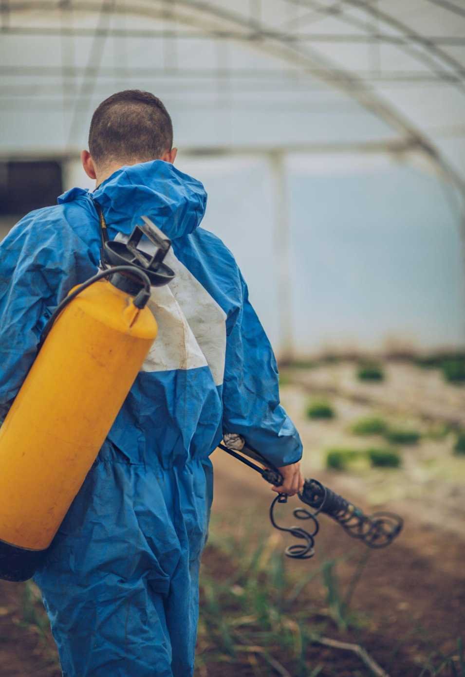 Pest control technician preparing spraying equipment